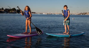 A boy and a girl paddling